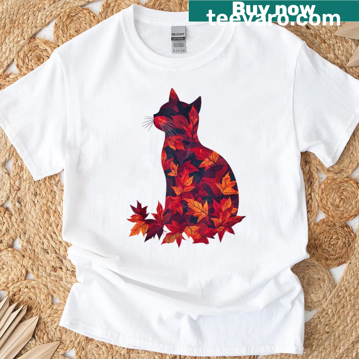 Cat surrounded by autumn leaves on dark red T-shirt — on a men's t-shirt
