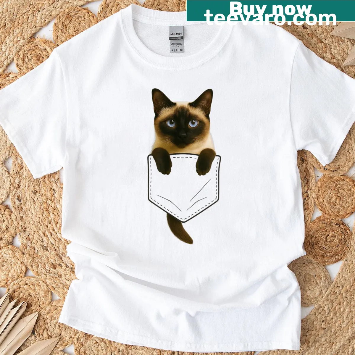 Illustrated Siamese cat peeking from a pocket on a t-shirt — on a men's t-shirt