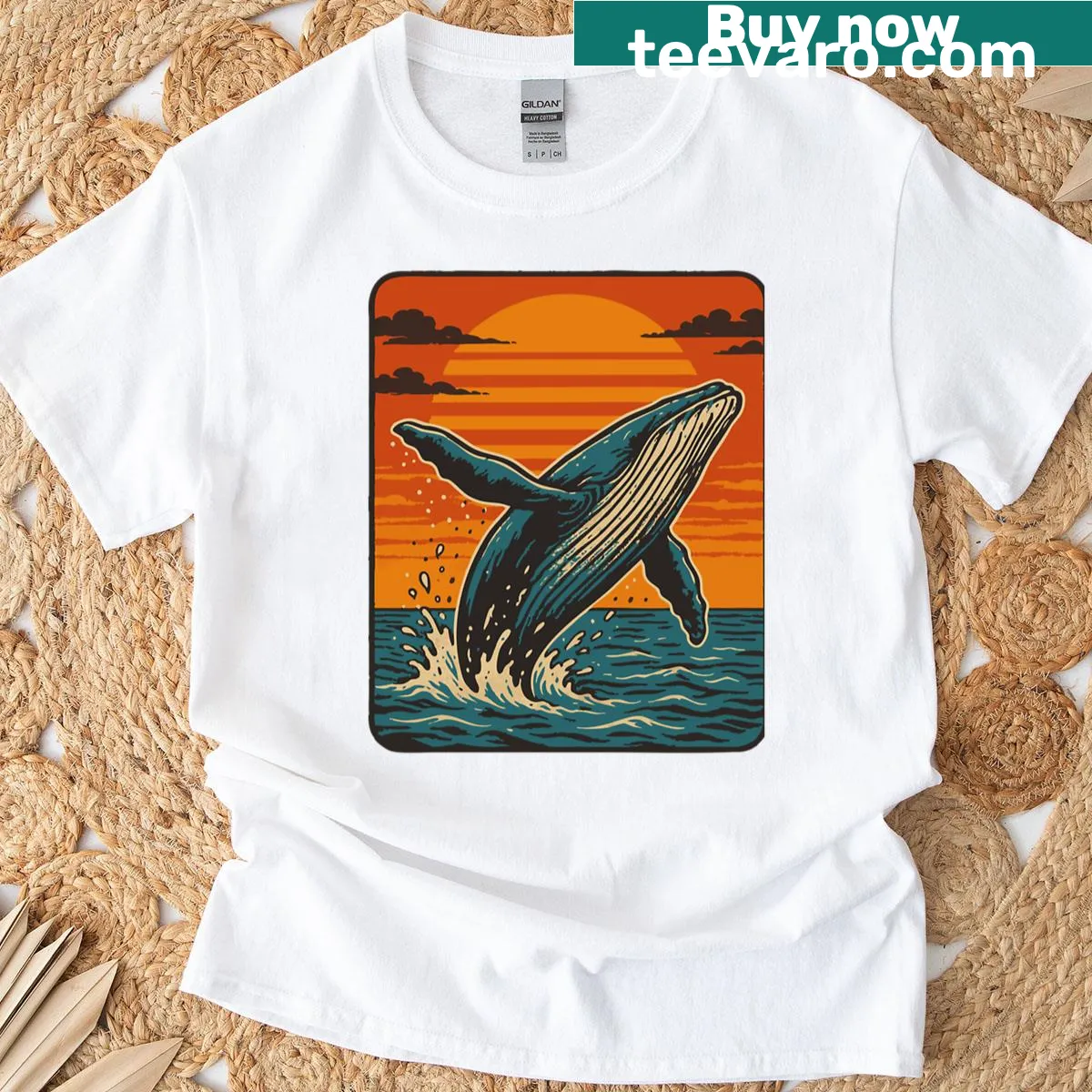 T-shirt featuring an illustration of a breaching humpback whale at sunset. — on a men's t-shirt