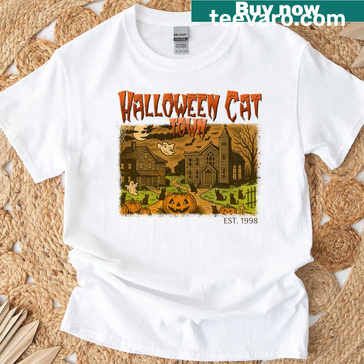 Graphic of cats in a Halloween-themed town design — on a men's t-shirt