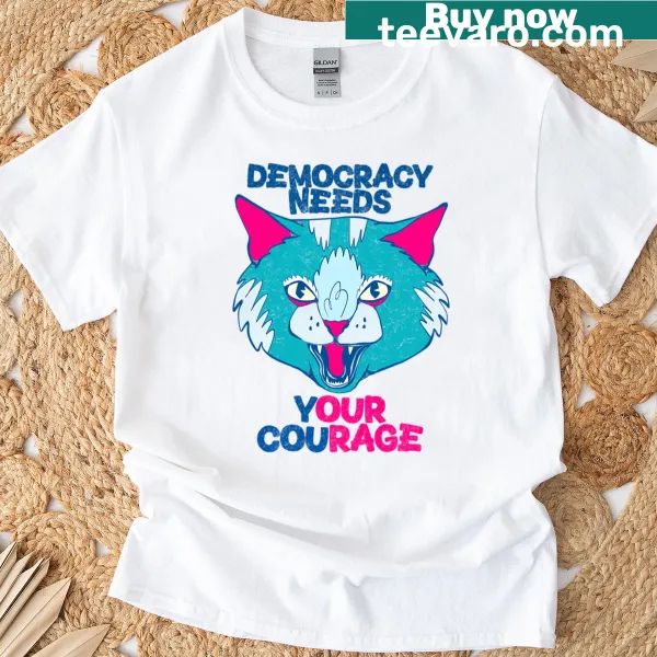 Cat illustration with text 'Democracy Needs Our Courage' on a tee
