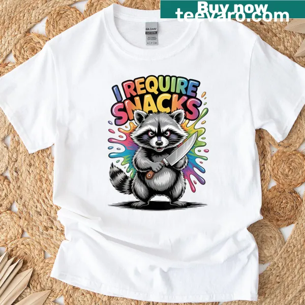 Funny Christmas T-shirt featuring a raccoon and the phrase 'I Require Snacks'