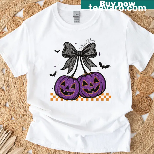 Cute Halloween T-shirt featuring pumpkins, cherries, and a bow design
