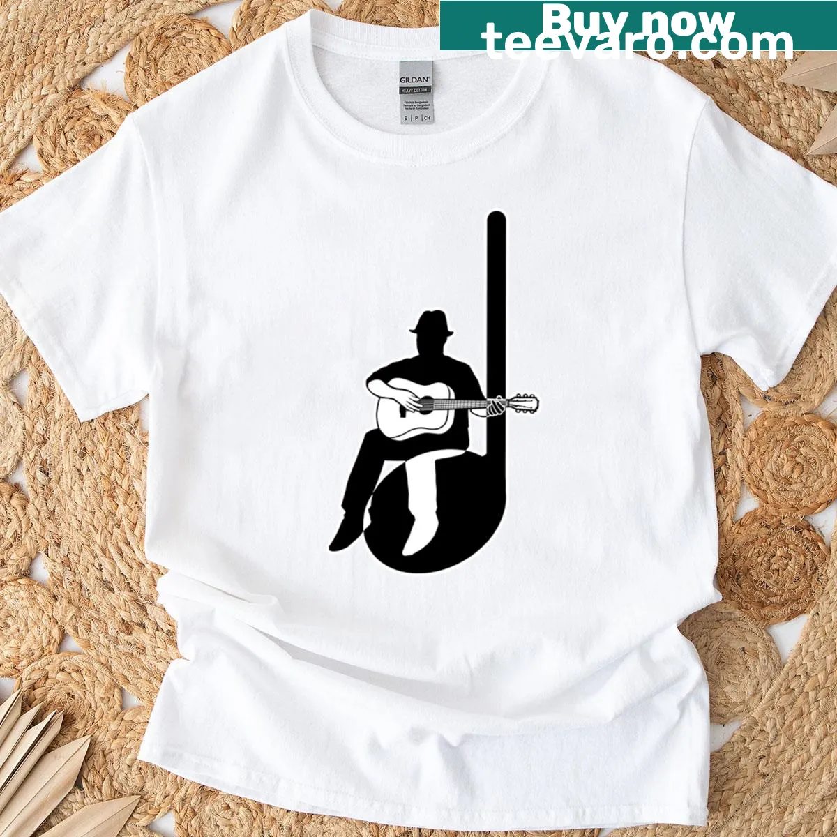 T-shirt featuring a graphic of an acoustic guitar and quarter note. — on a men's t-shirt
