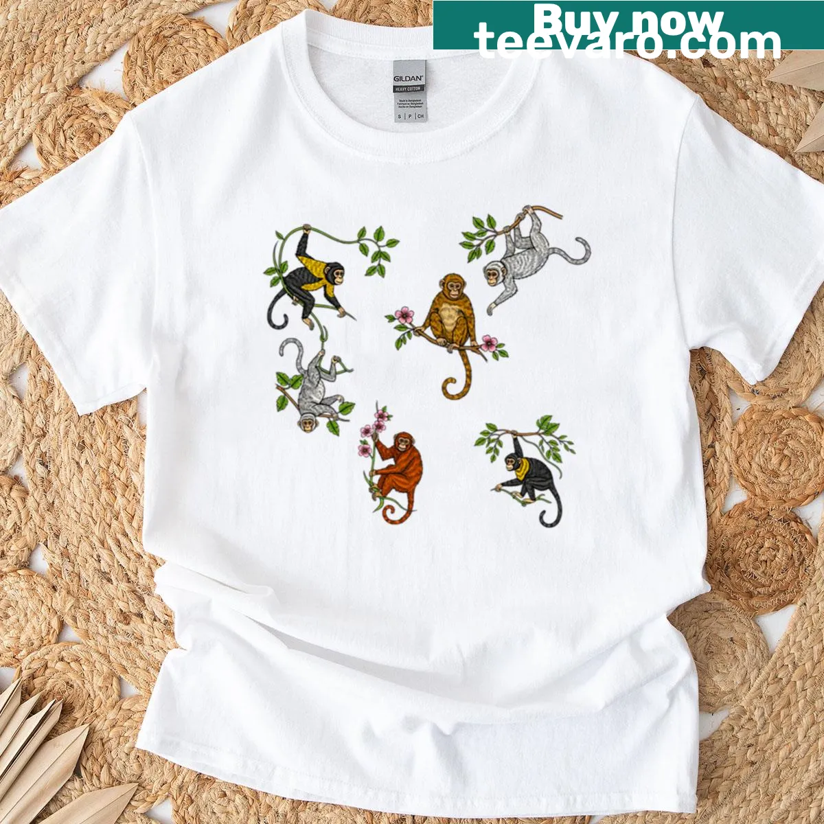 Playful t-shirt featuring monkeys hanging from tree branches — on a men's t-shirt
