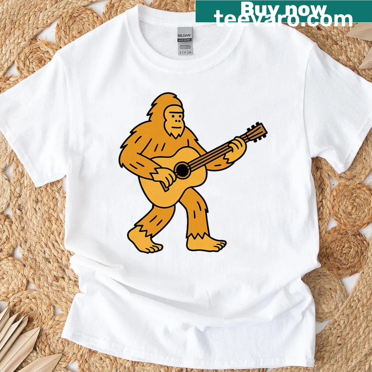 Cartoon Bigfoot playing acoustic guitar design on T-shirt — on a men's t-shirt