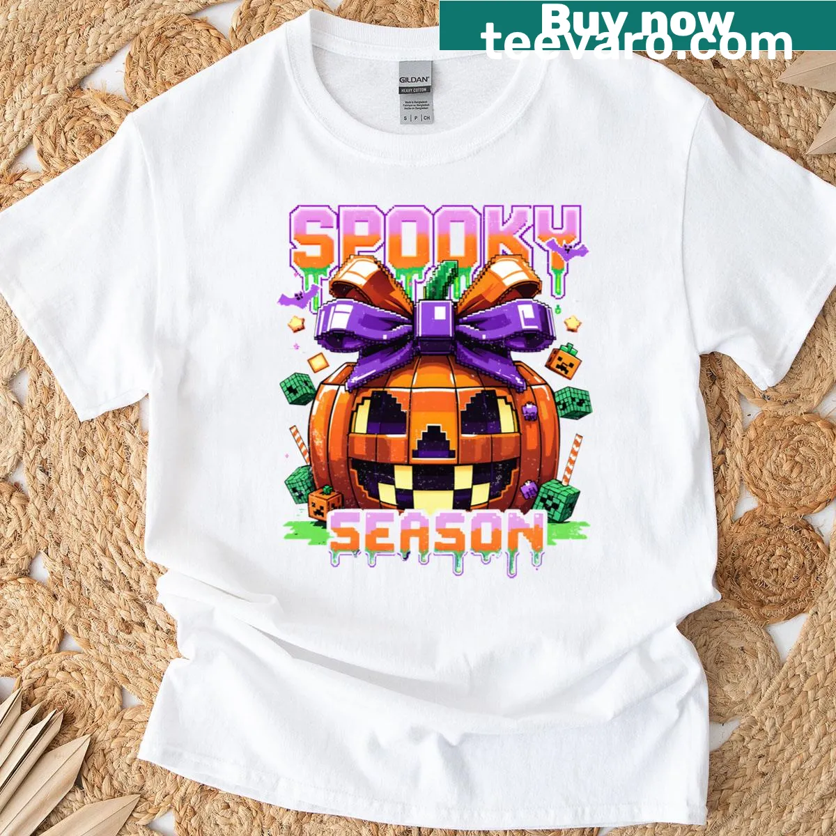 Pixel art pumpkin graphic with purple bow for Halloween — on a men's t-shirt