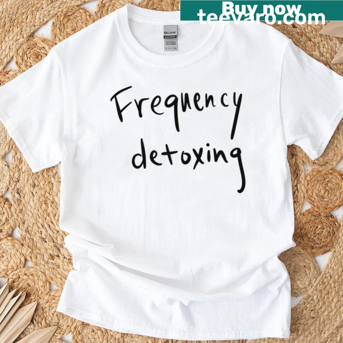 Minimalist typography design on a Frequency Detoxing t-shirt — on a men's t-shirt