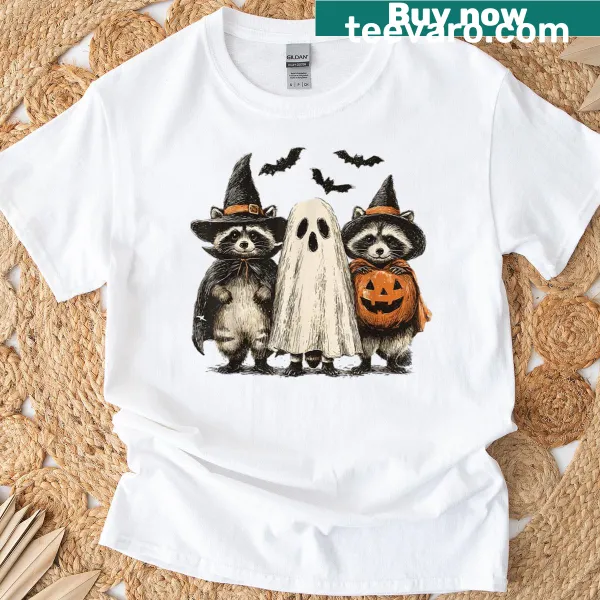 Whimsical Halloween shirt with a ghost raccoon and pumpkin graphic.