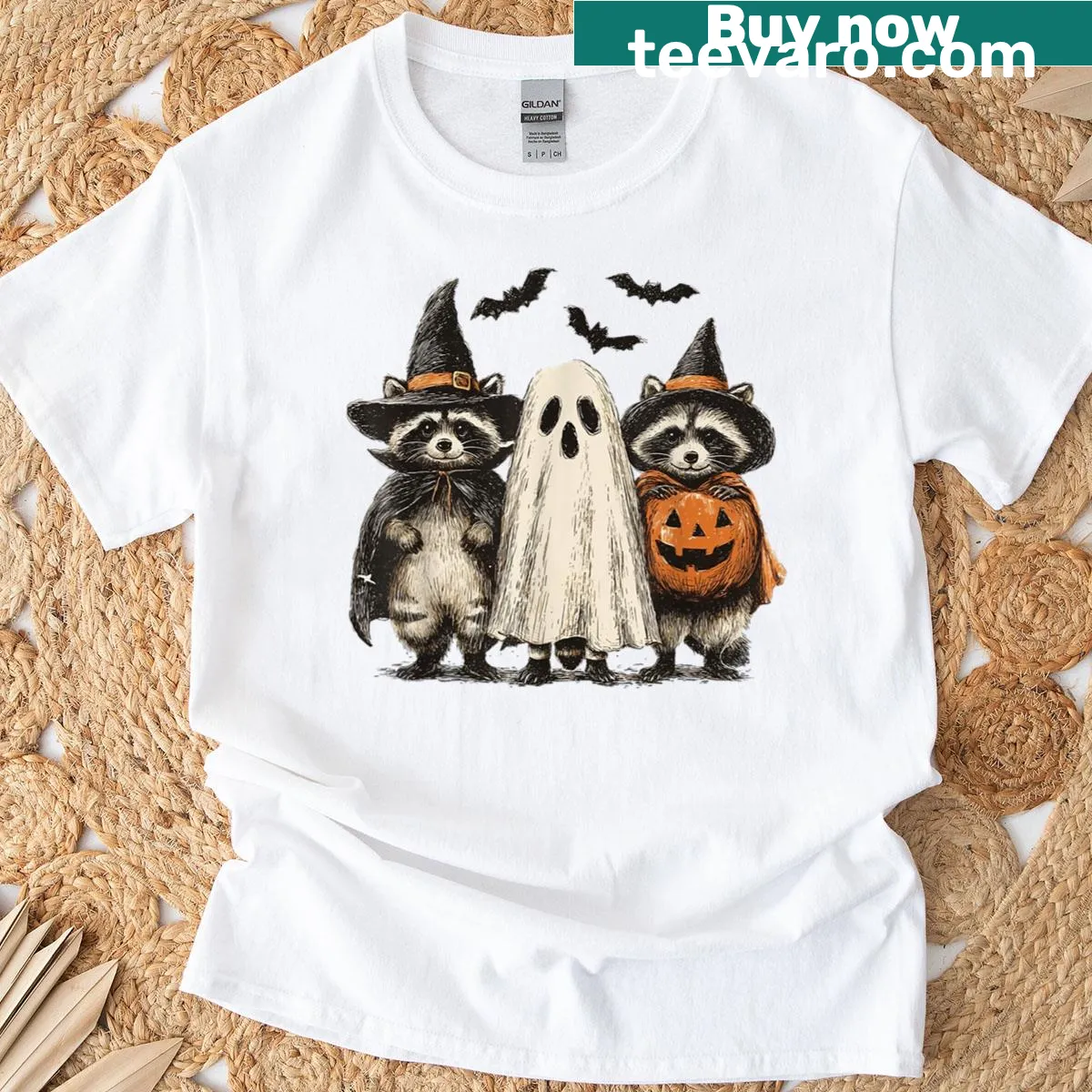 Whimsical Halloween shirt with a ghost raccoon and pumpkin graphic. — on a men's t-shirt