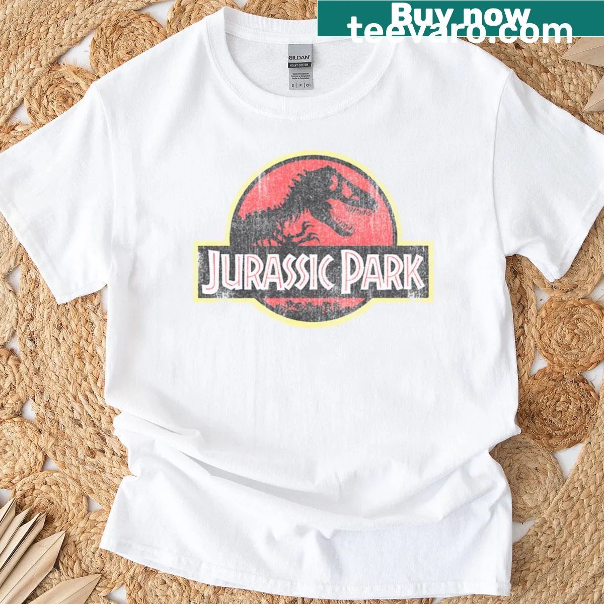 Distressed retro T-shirt featuring Jurassic Park logo in red — on a men's t-shirt