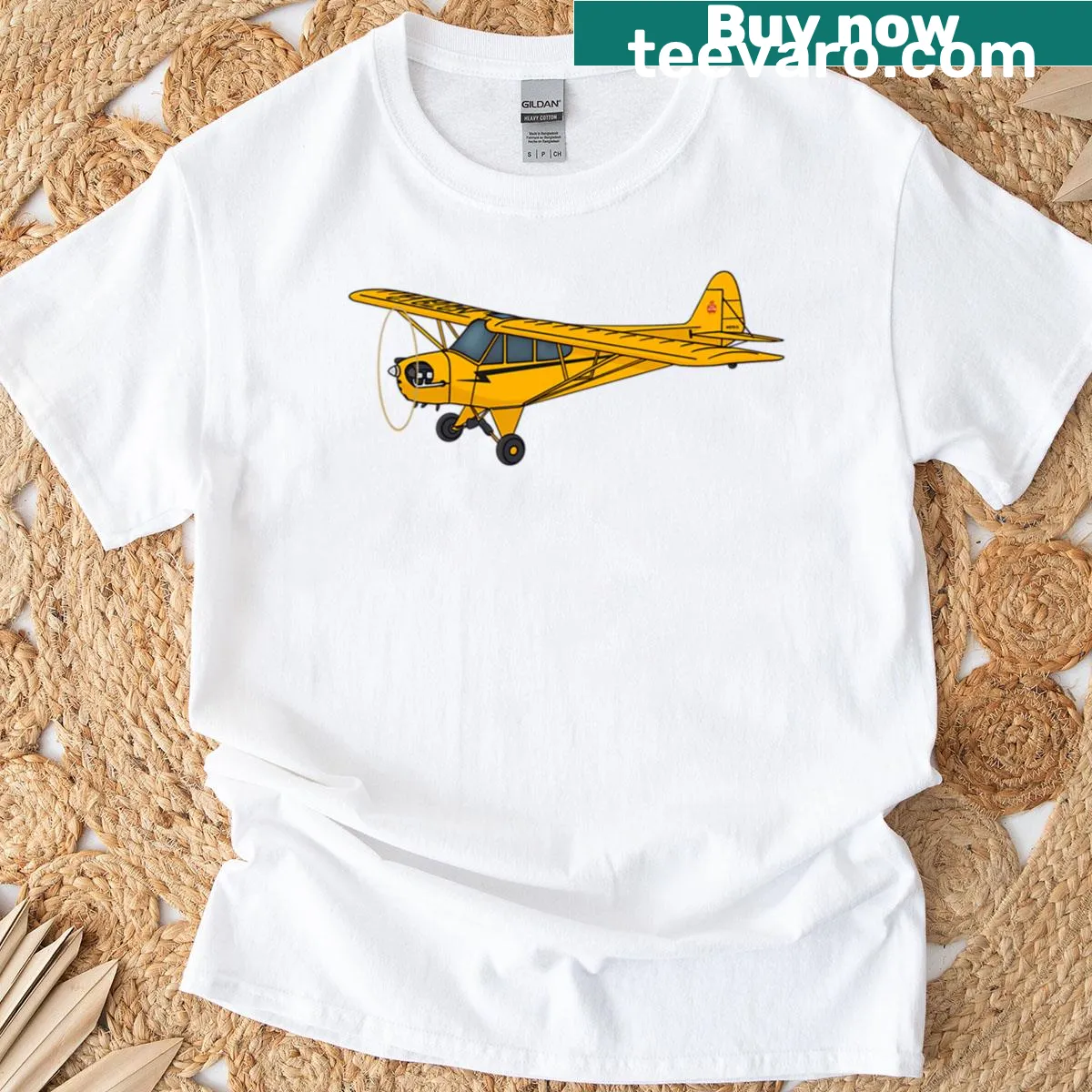 Illustrated oversized T-shirt featuring the Piper J-3 Cub airplane — on a men's t-shirt
