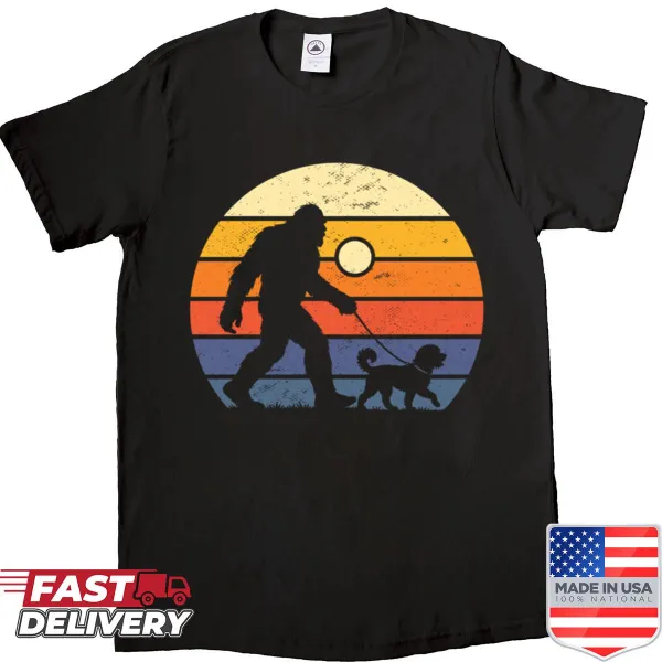 Shirt featuring Bigfoot and a Portuguese Water Dog in a vintage sunset scene