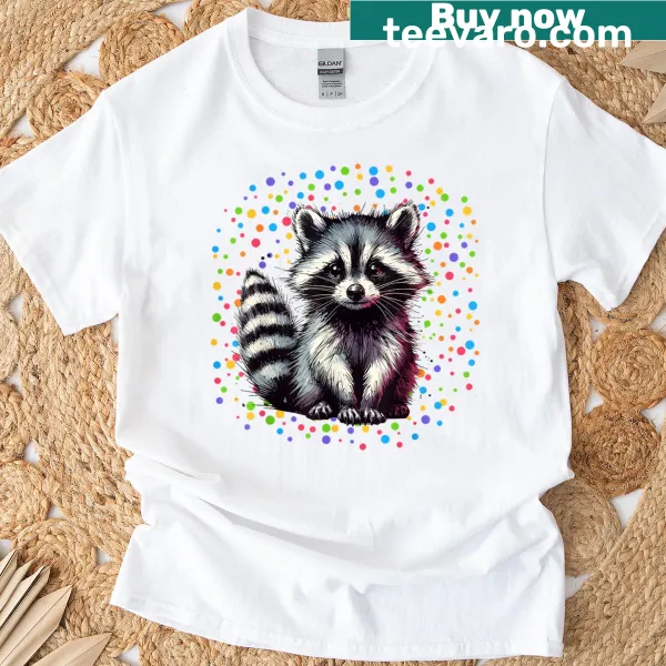 Cartoon raccoon surrounded by rainbow polka dots on creativity-themed shirt
