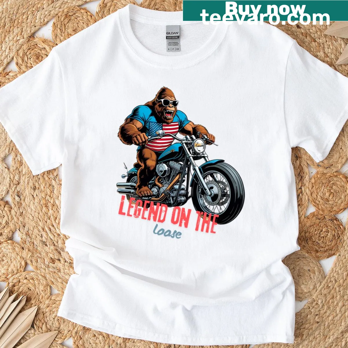 Bigfoot riding a vintage motorcycle in a humorous graphic design. — on a men's t-shirt