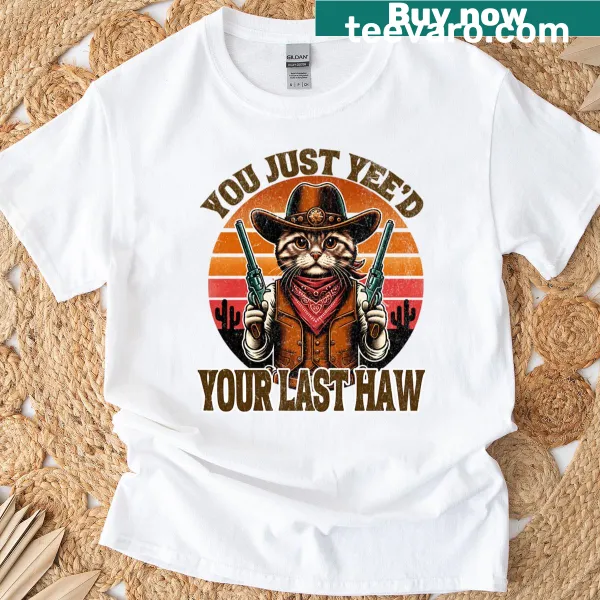 Vintage-style T-shirt featuring a cowboy cat with a funny quote