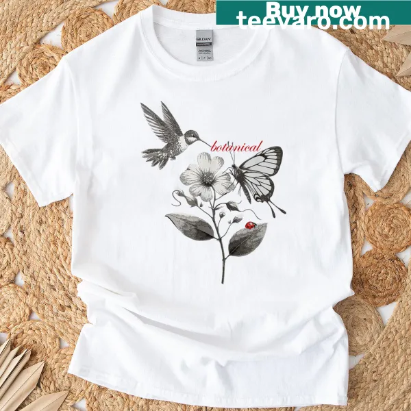 Illustrative t-shirt featuring birds, butterflies, hummingbird, and ladybug in a botanical design