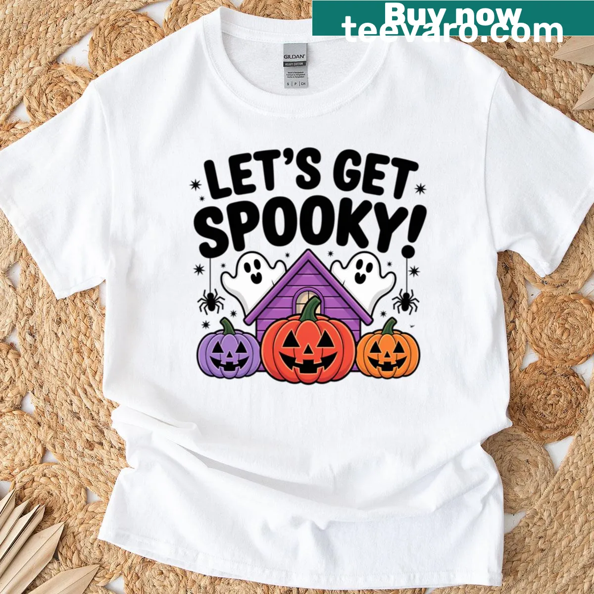 Halloween T-shirt featuring a haunted house and pumpkins illustration — on a men's t-shirt