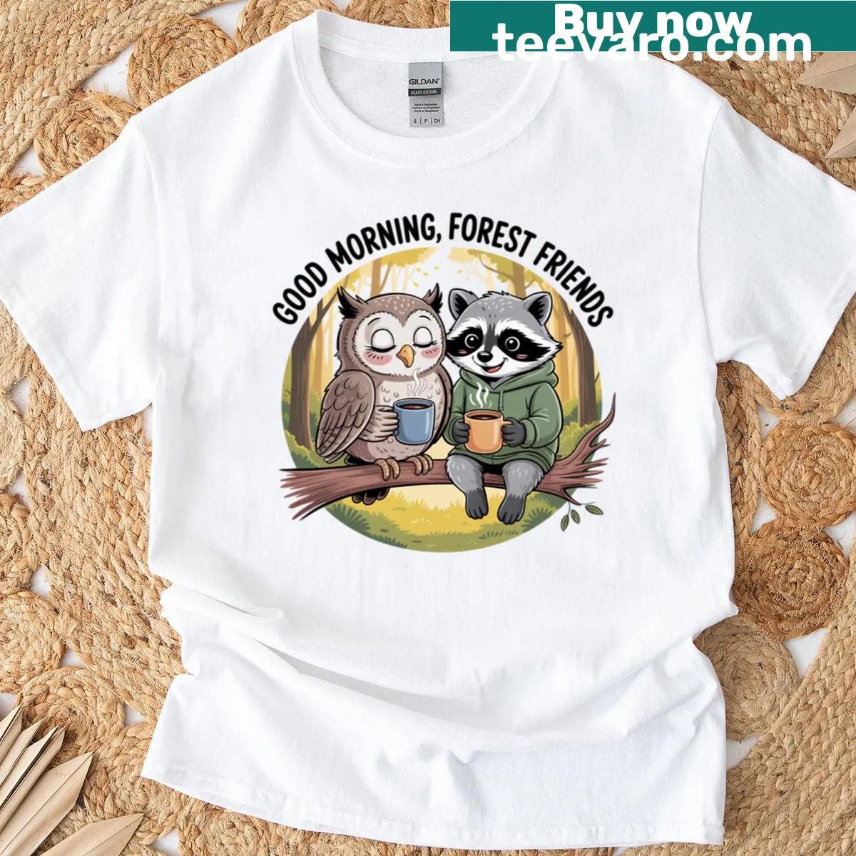 Owl and raccoon sharing coffee in a whimsical forest setting graphic — on a men's t-shirt