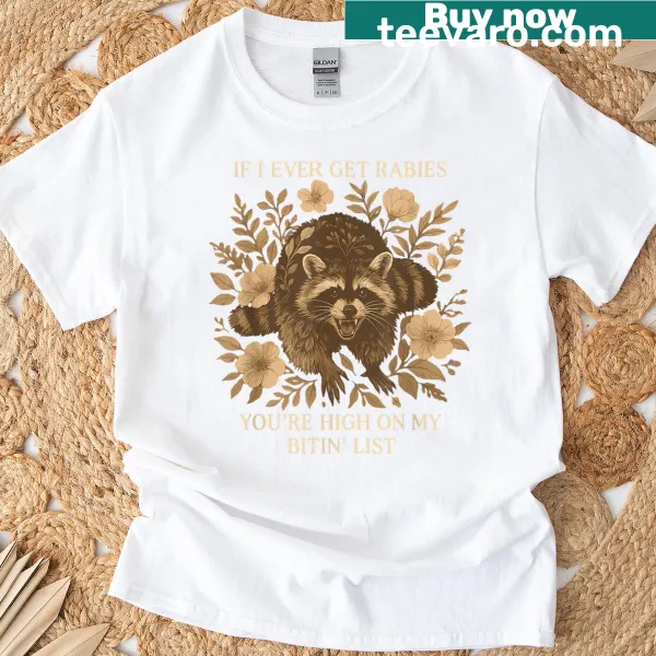Whimsical raccoon graphic with a biting list on a T-shirt