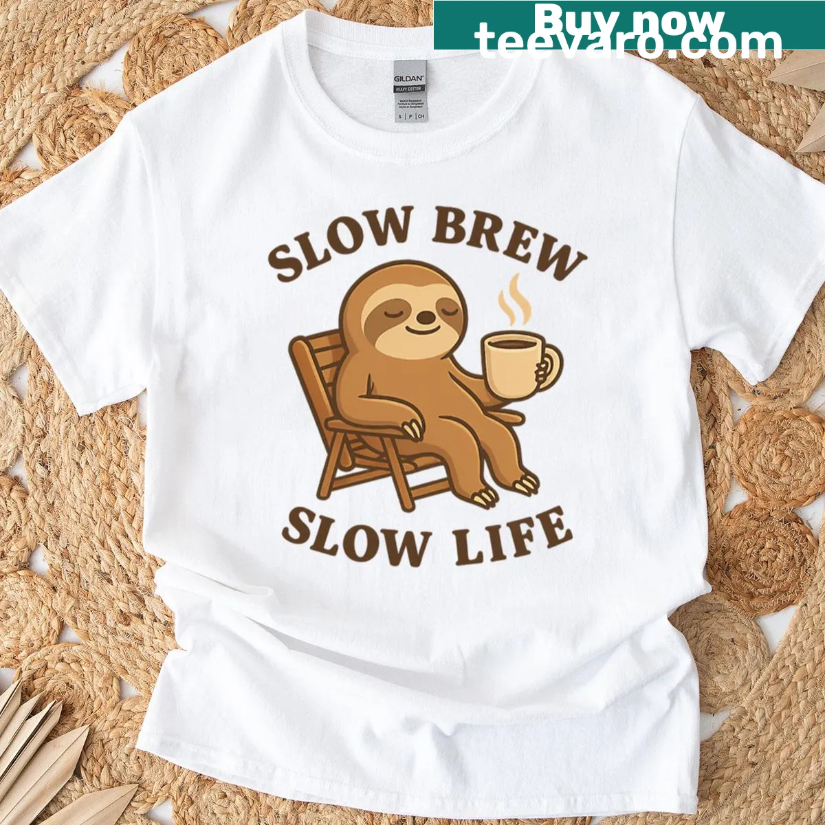 Cute sloth graphic enjoying coffee on oversized T-shirt — on a men's t-shirt