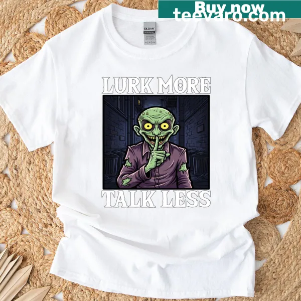 Halloween t-shirt featuring a playful monster graphic with the phrase 'Lurk More Talk Less'