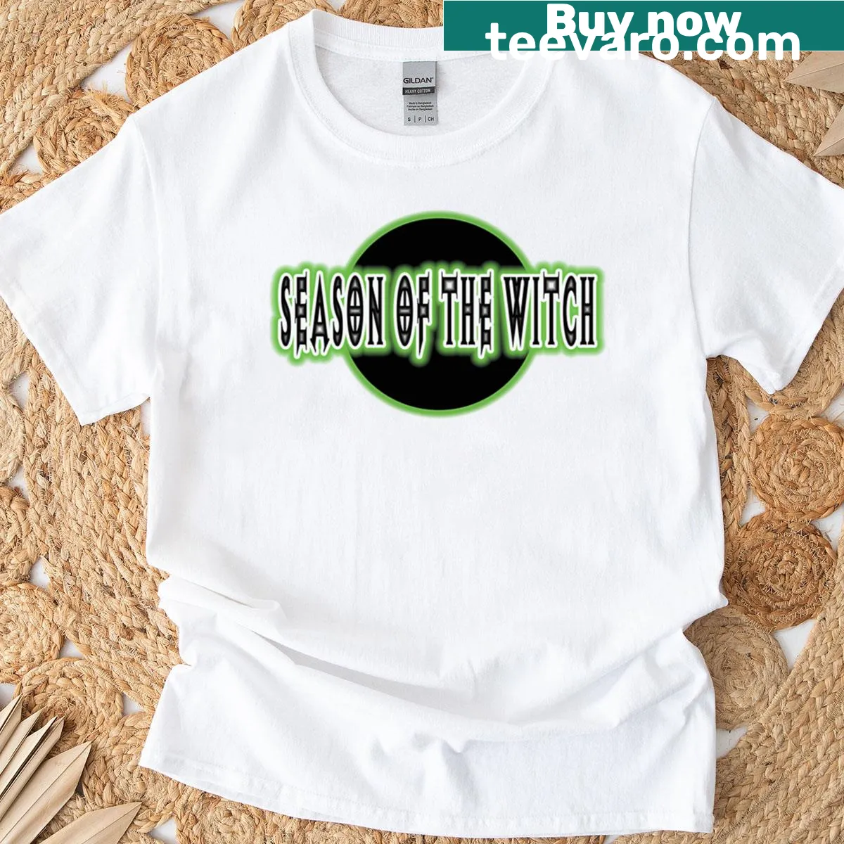 Graphic T-shirt featuring a whimsical witch with pumpkins and bats — on a men's t-shirt