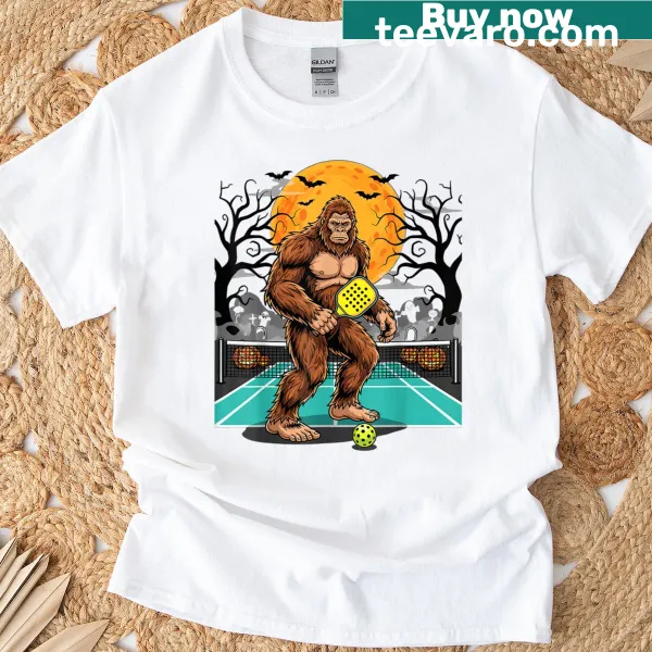 Sasquatch playing pickleball under the moon on graphic t-shirt