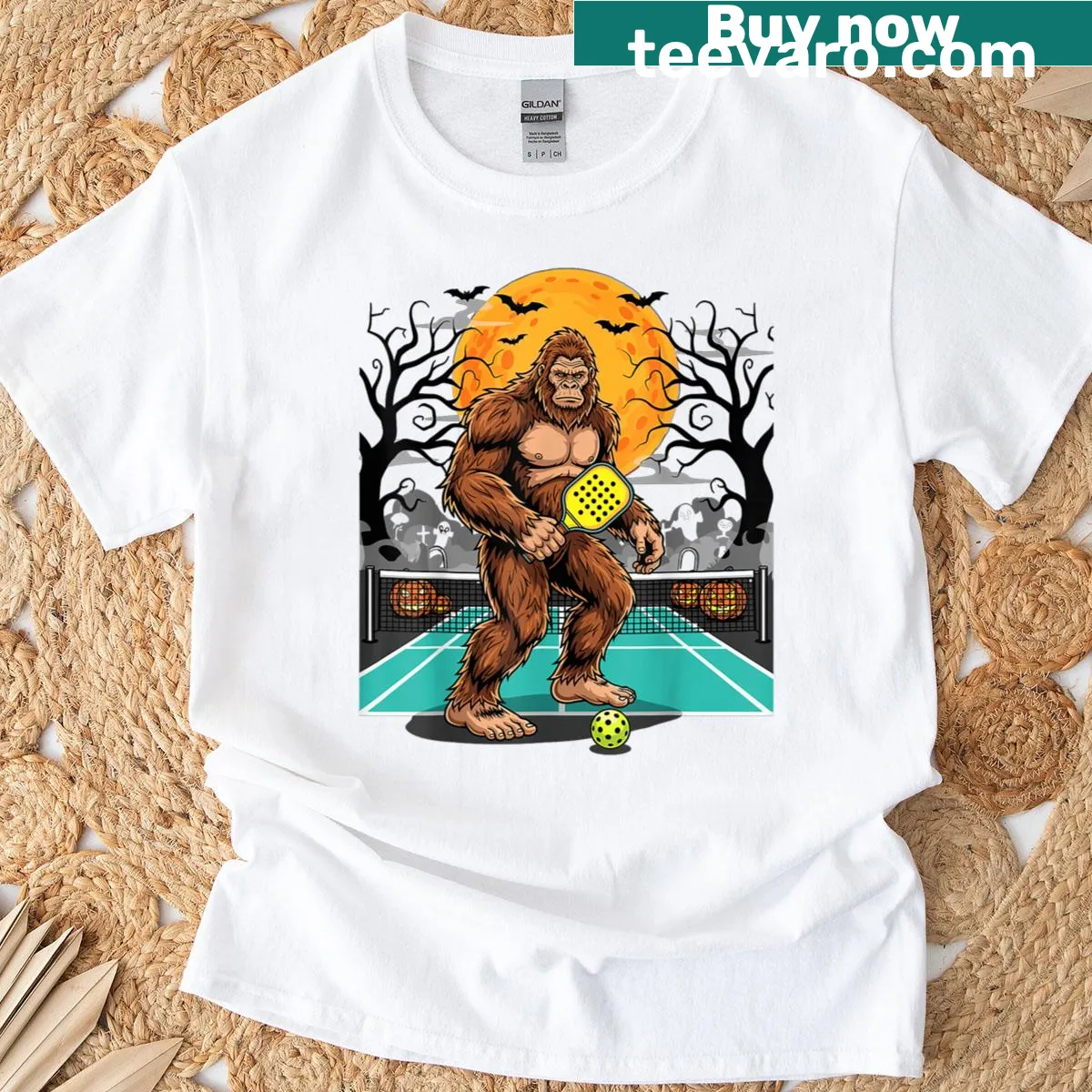 Sasquatch playing pickleball under the moon on graphic t-shirt — on a men's t-shirt