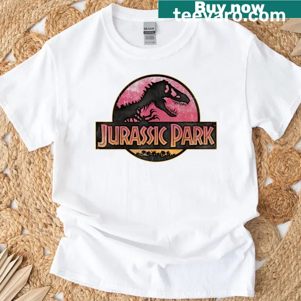 Illustrated Jurassic Park logo t-shirt with a gradient sunset background.