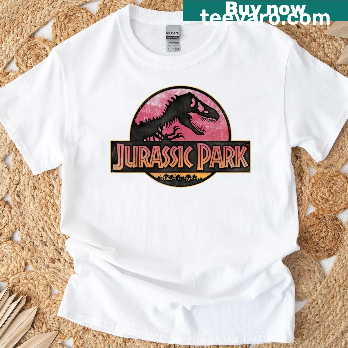 Illustrated Jurassic Park logo t-shirt with a gradient sunset background. — on a men's t-shirt