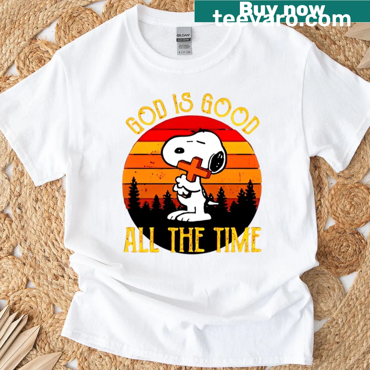 Snoopy illustration with the phrase God Is Good against a sunset background — on a men's t-shirt