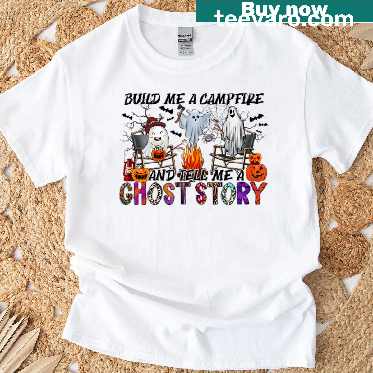 Humorous Halloween T-shirt with a ghost by a campfire — on a men's t-shirt