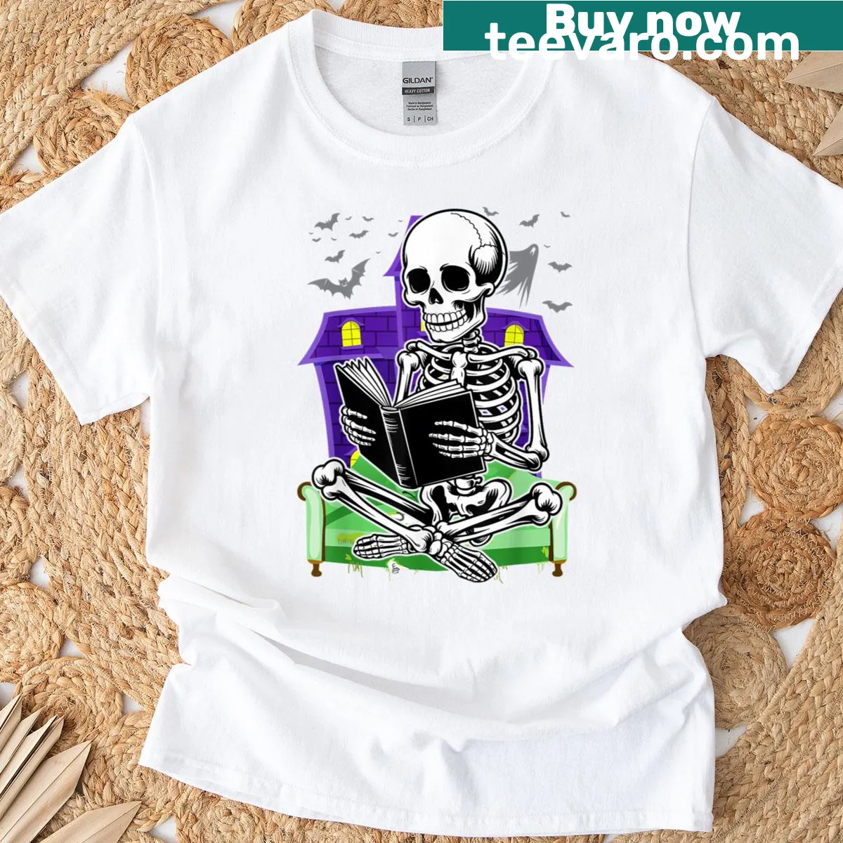 Skeleton reading a book graphic on a Halloween T-shirt — on a men's t-shirt