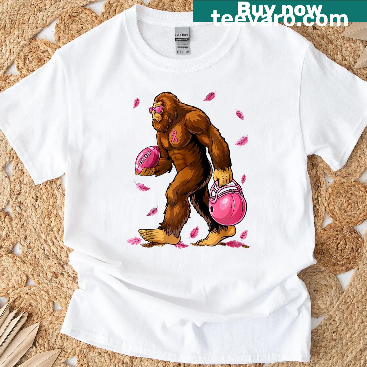 Fun t-shirt featuring Bigfoot playing football with a pink ribbon. — on a men's t-shirt