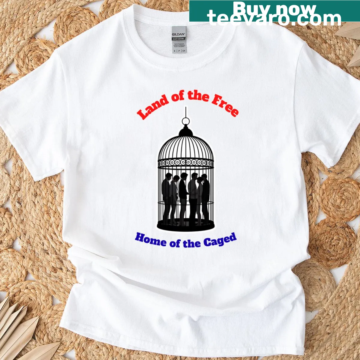 Patriotic T-shirt with the phrase 'Land Of The Free Home Of The Caged' in bold typography — on a men's t-shirt