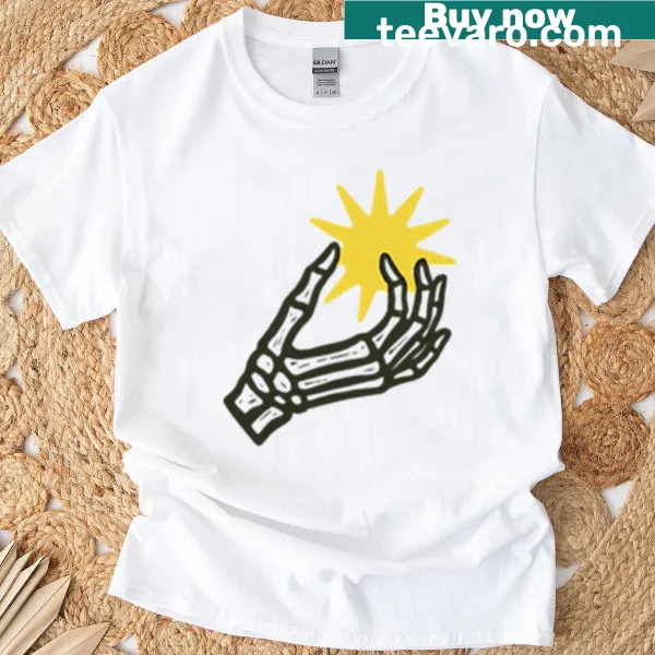 Skeleton hand holding a tiny sun graphic on oversized t-shirt