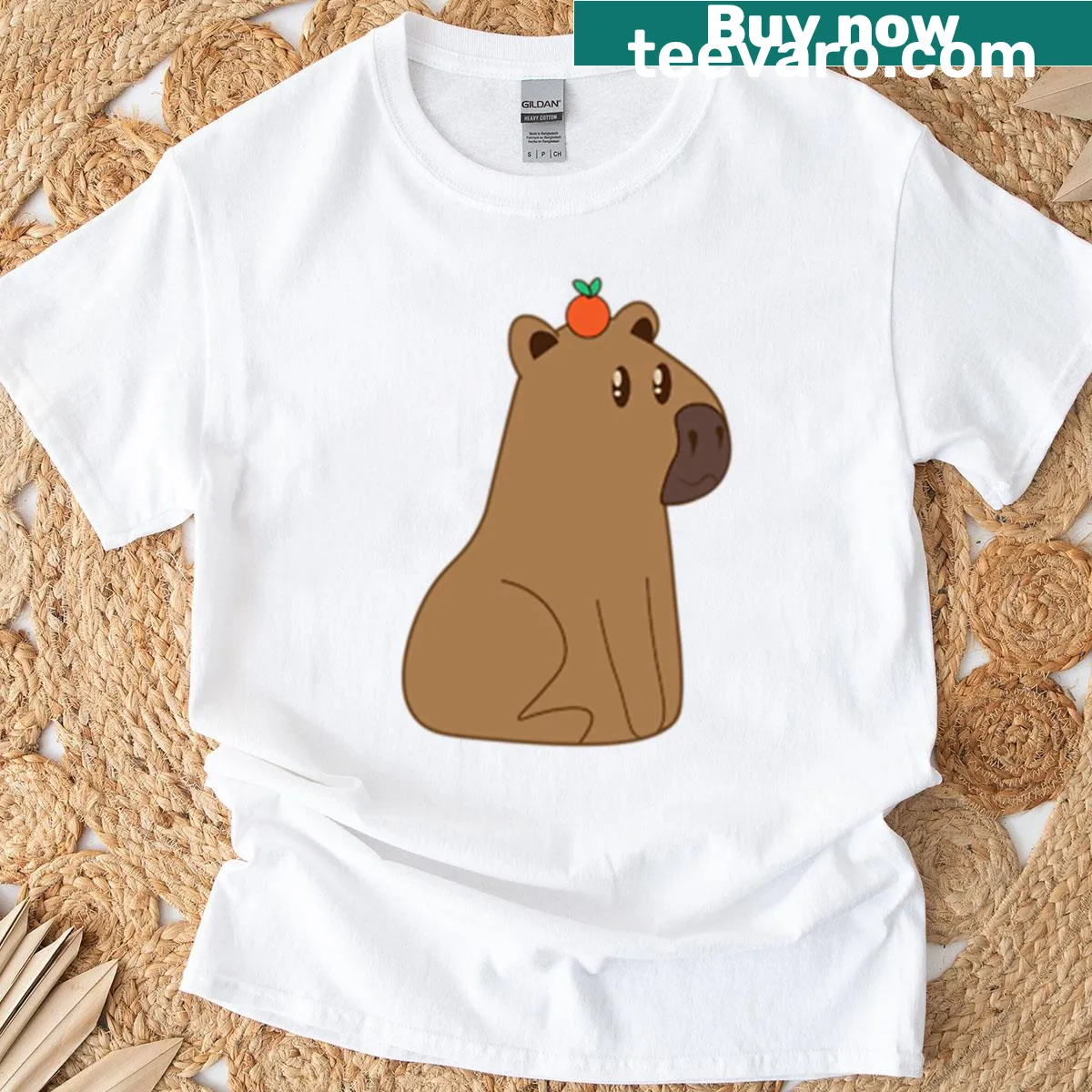 Cute capybara with orange on head t-shirt design — on a men's t-shirt