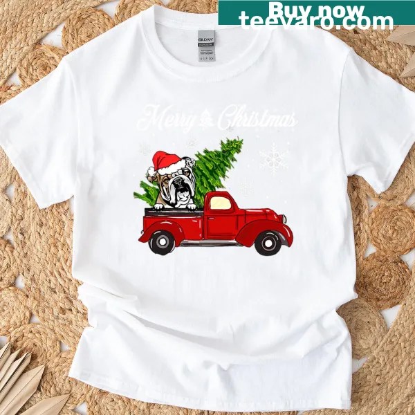 English Bulldog in a red truck with Christmas decorations