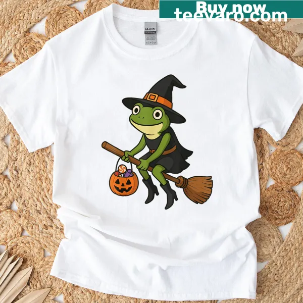 Cartoon frog in a witch hat next to a pumpkin on a T-shirt