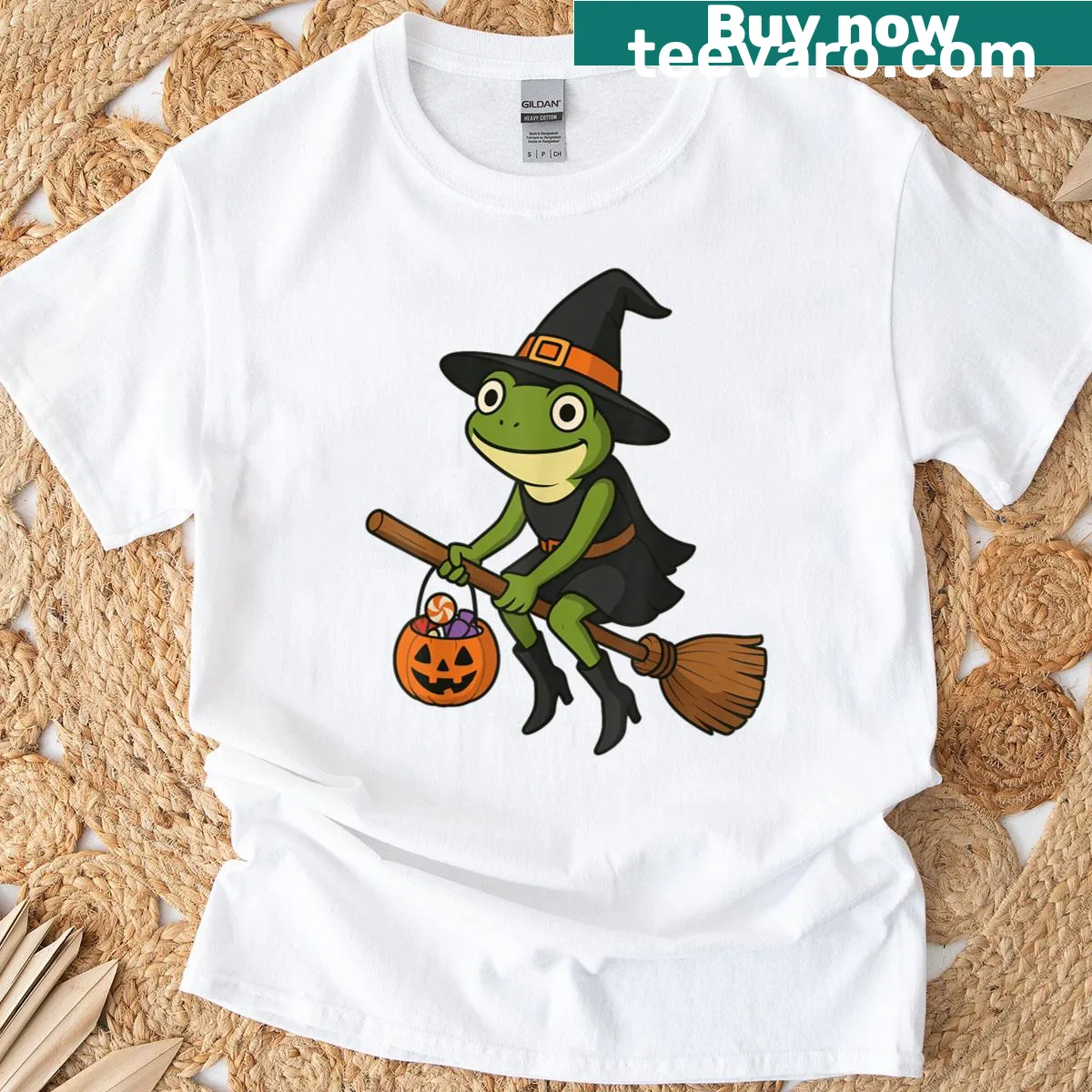 Cartoon frog in a witch hat next to a pumpkin on a T-shirt — on a men's t-shirt