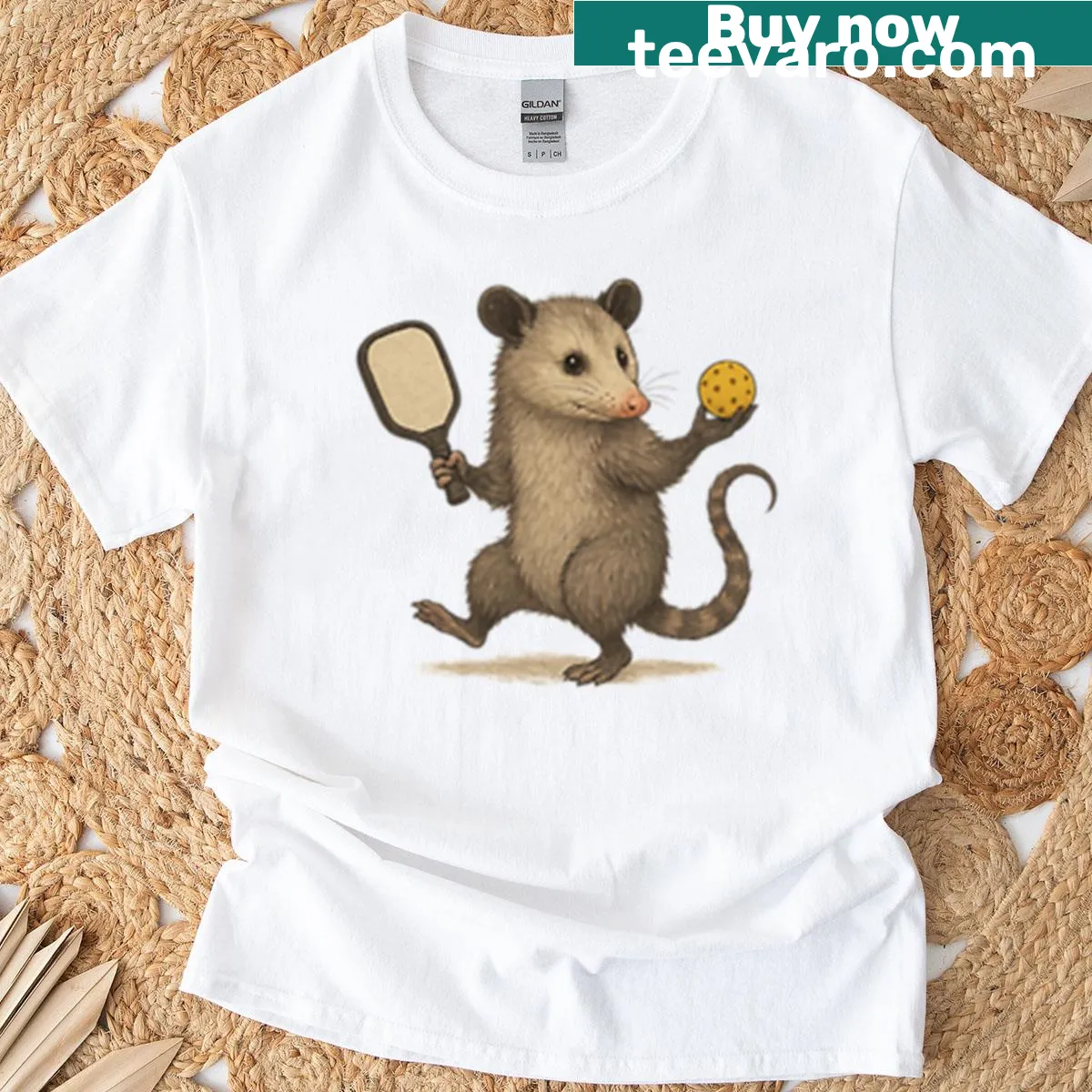 Playful T-shirt with a cartoon opossum and pickleball theme — on a men's t-shirt