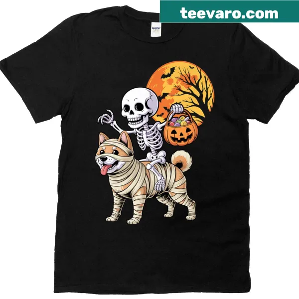 Halloween t-shirt featuring a skeleton riding a mummy Shiba Inu