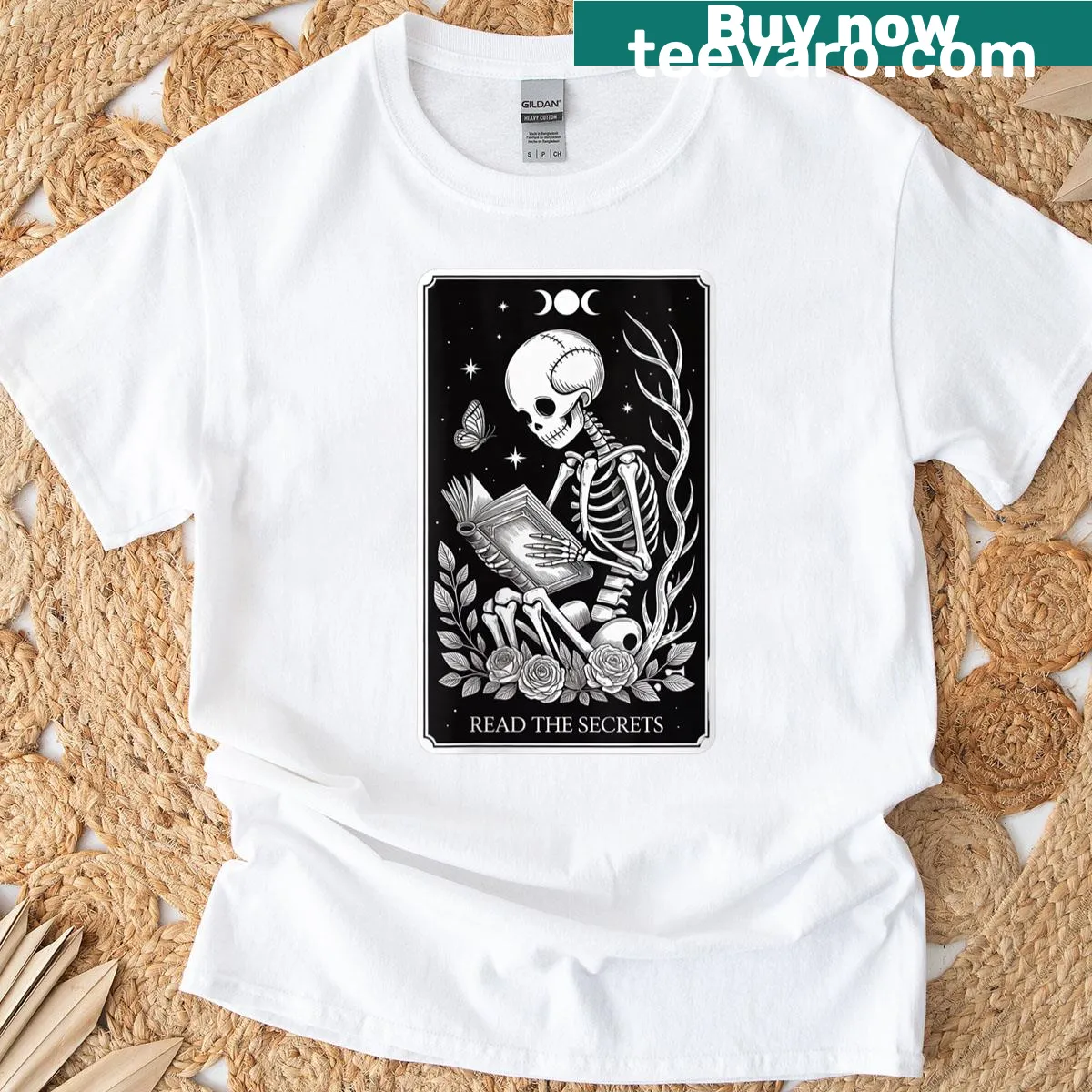 Skeleton reading a book in a tarot card design on a T-shirt — on a men's t-shirt