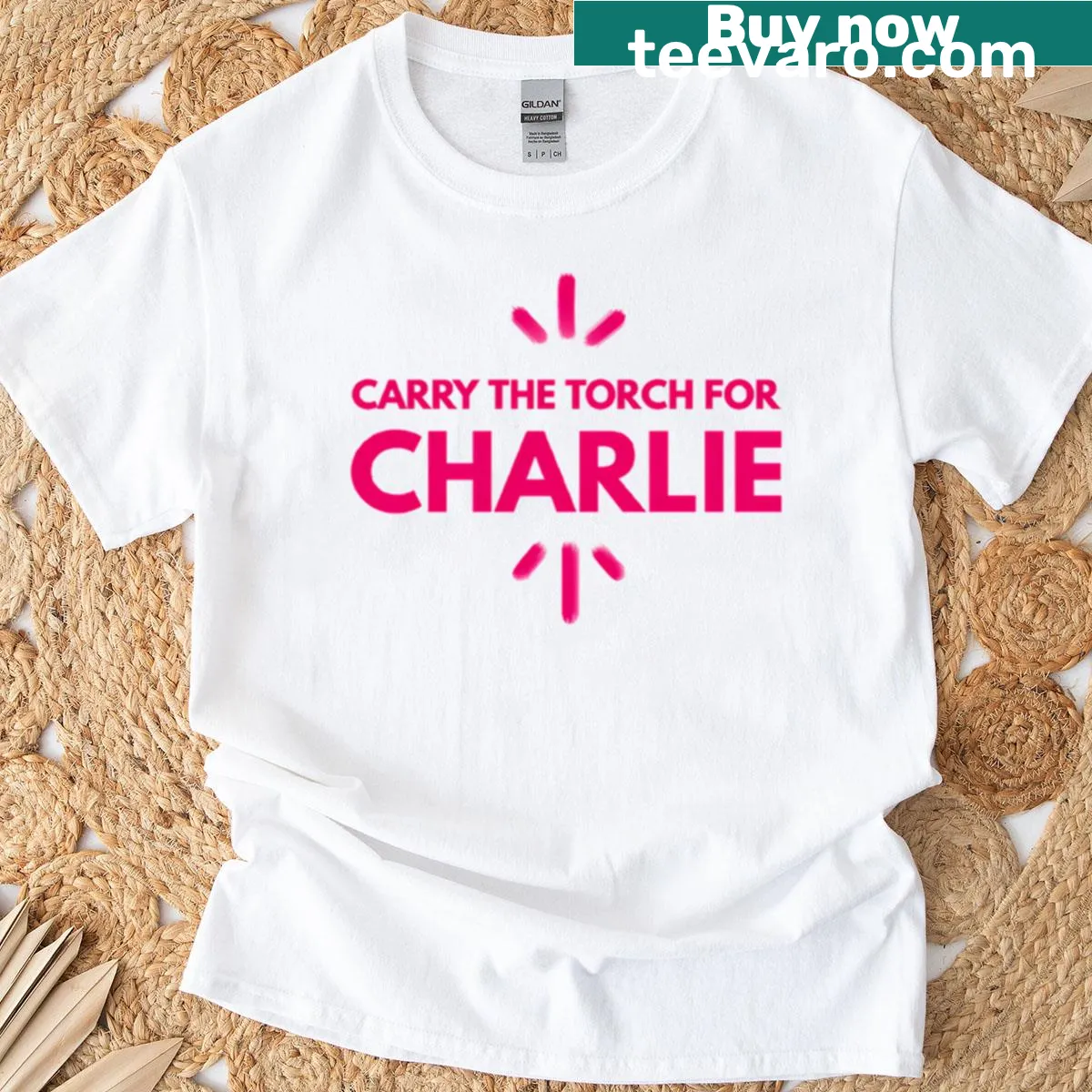 Text graphic stating 'Carry The Torch For Charlie Kirk' — on a men's t-shirt