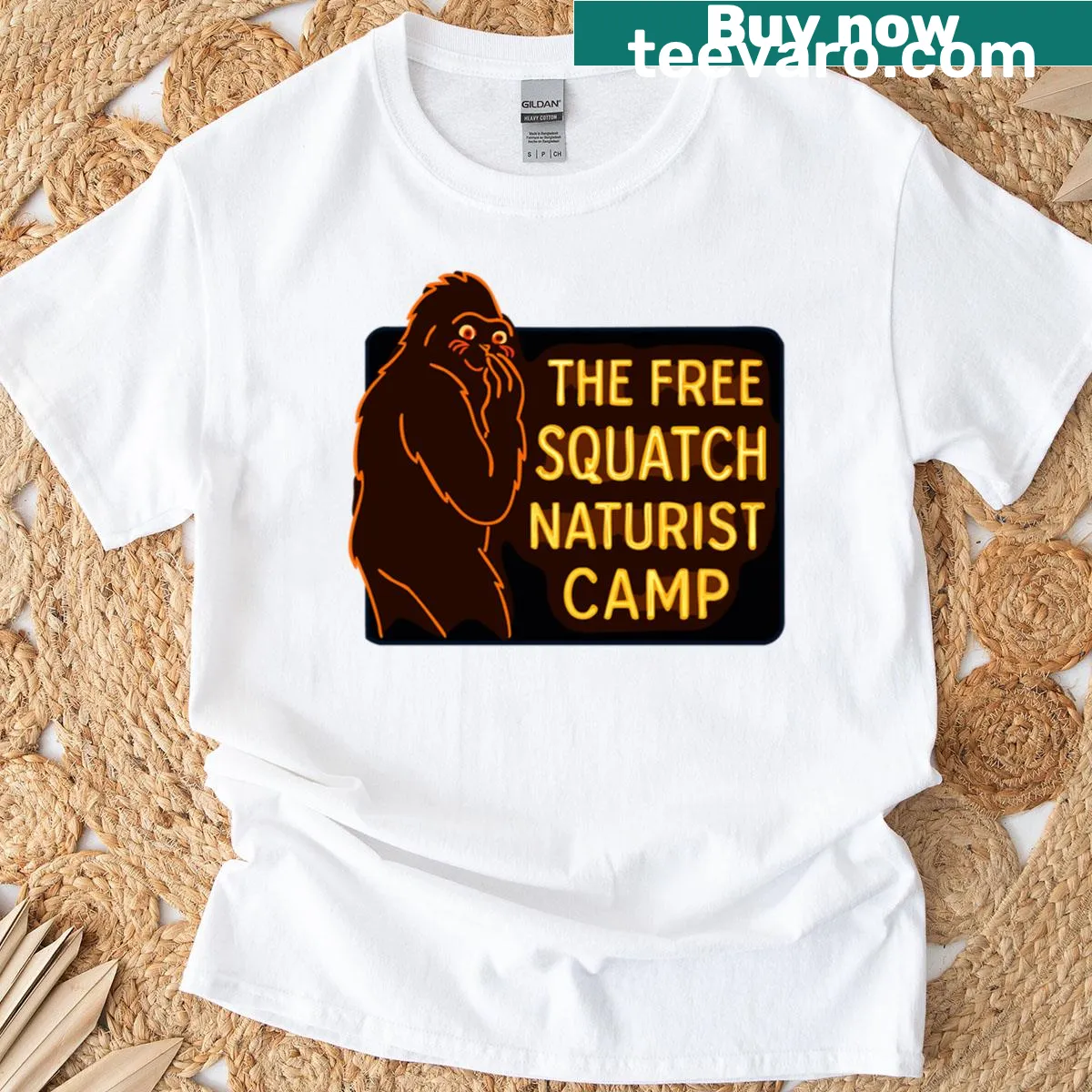 Badge-style graphic of a naturist camp for Bigfoot on a t-shirt — on a men's t-shirt