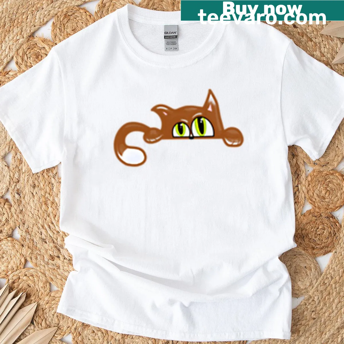 Playful cat peeking graphic on oversized t-shirt — on a men's t-shirt