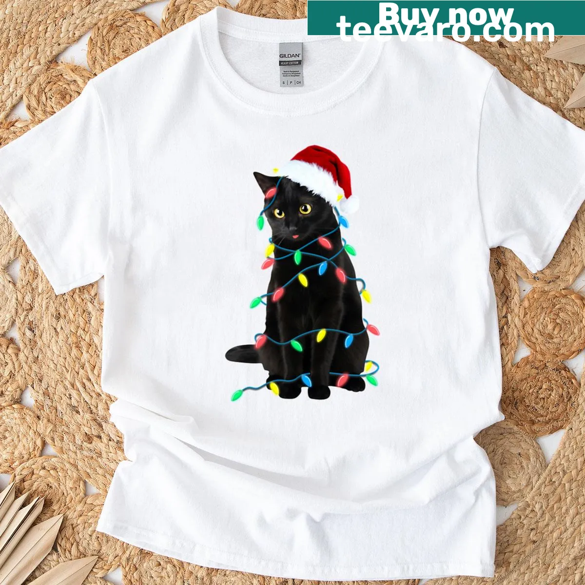 Illustration of a black cat with a Santa hat wrapped in Christmas lights — on a men's t-shirt