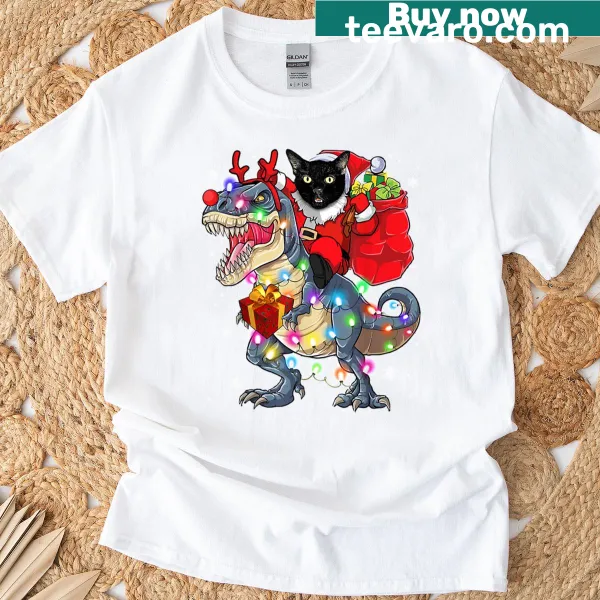 T-shirt featuring a cat riding a T-Rex for a humorous holiday design.