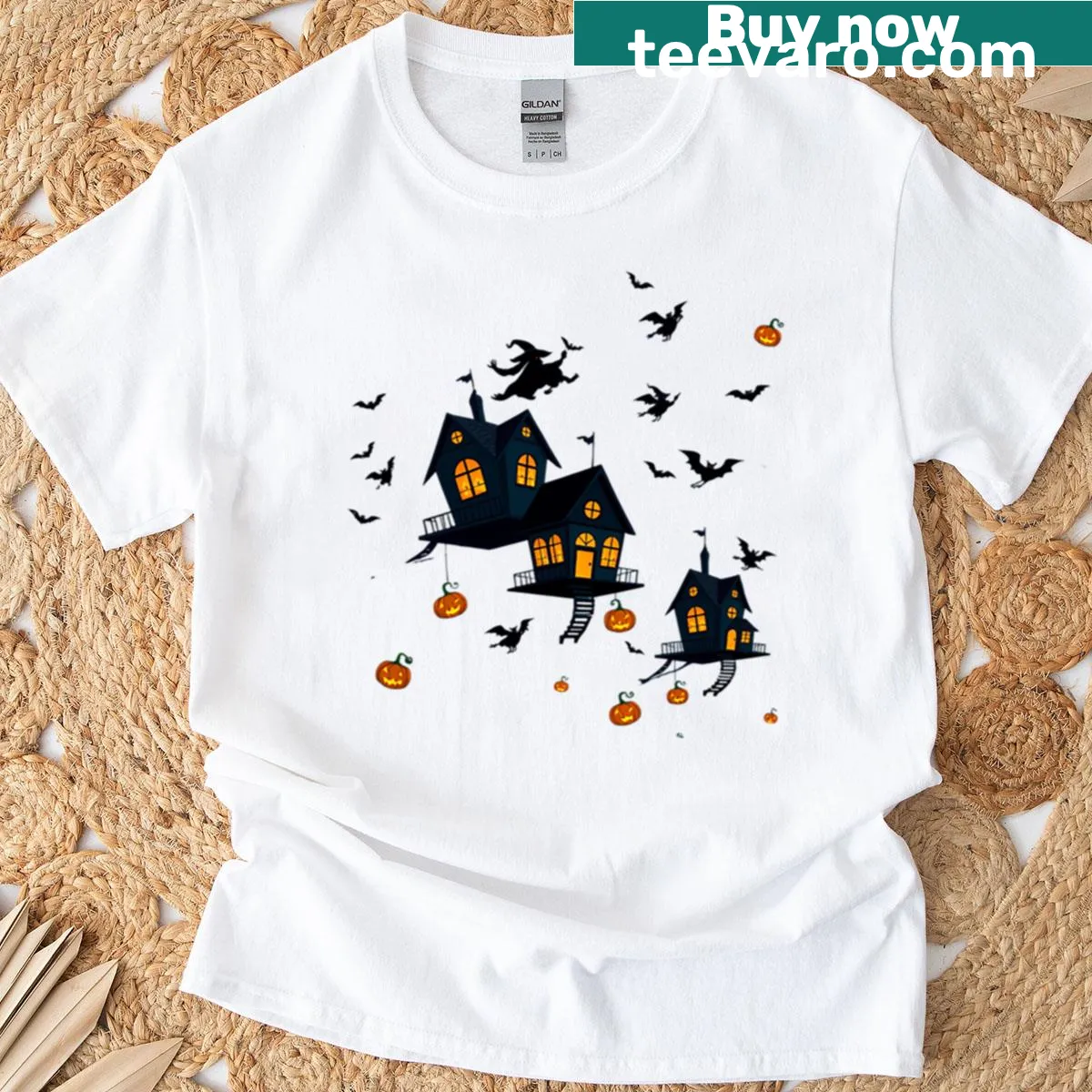 Whimsical Halloween-themed T-shirt with a haunted sky parade illustration — on a men's t-shirt